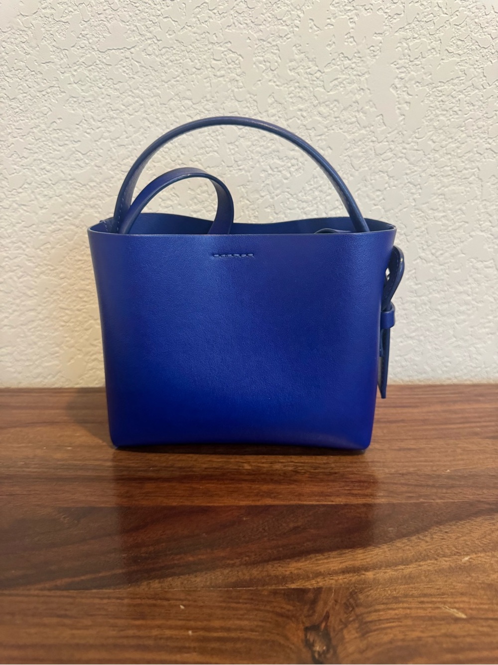 ARKET small leather cross-body tote bag with side buckle detail in blue